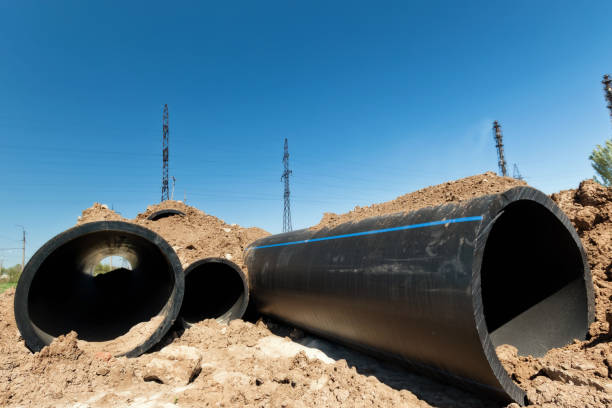 istock Installation works on replacement  steel pipelines with thick-walled pipes made of polymeric materials 956565974