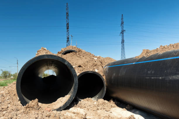 istock Installation works on replacement  steel pipelines with thick-walled pipes made of polymeric materials 956566178
