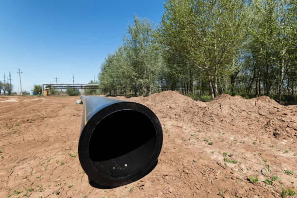 istock Installation works on replacement  steel pipelines with thick-walled pipes made of polymeric materials 956568964