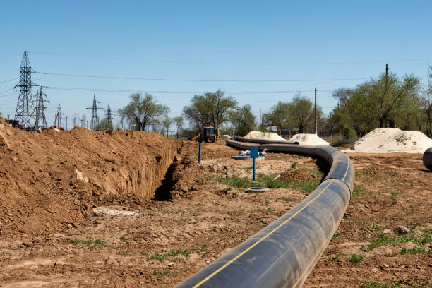 istock Installation works on replacement  steel pipelines with thick-walled pipes made of polymeric materials 956569304
