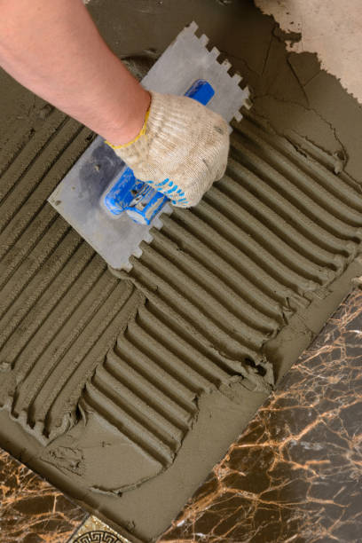 istock Close-up of a master's hand that makes furrows in a glutinous solution 956576410
