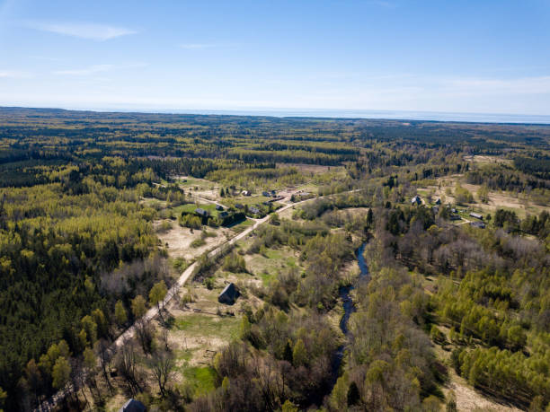 istock drone image. aerial view of rural area with river in forest from above 956576772
