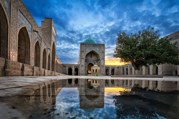 Kalyan Mosque at dusk in Bukhara, Uzbekistan Inner courtyard of the Kalyan Mosque, part of the Po-i-Kalyan Complex in Bukhara, Uzbekistan madressa photos stock pictures, royalty-free photos & images