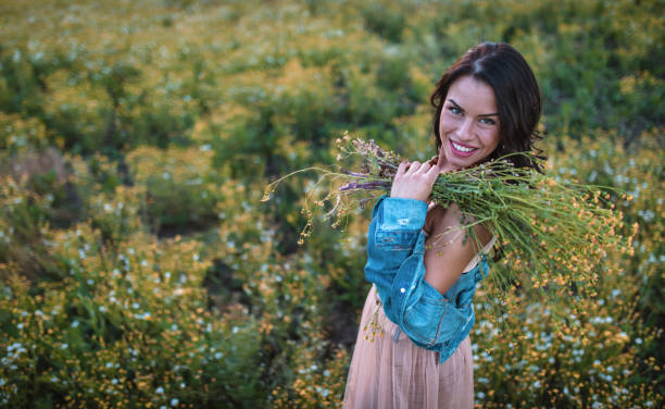 istock Gorgeous girl holding flowers 956579252