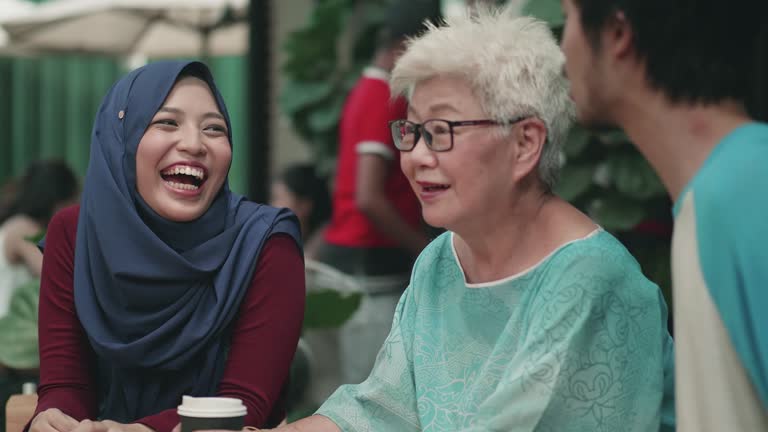 Young woman and man spending time with grandmother