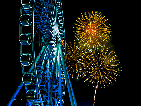 Ferris wheel on firework background