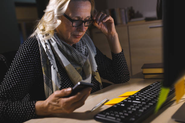 istock Mature businesswoman working on desktop at night. 956597018