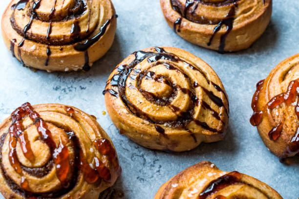 istock Freshly Baked Cinnamon Rolls with Caramel and Chocolate Sauce. 956597110