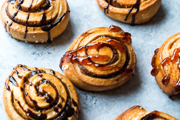 istock Freshly Baked Cinnamon Rolls with Caramel and Chocolate Sauce. 956597392
