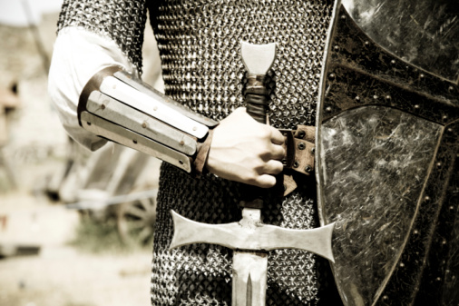 Man in suit of armor with medieval sword