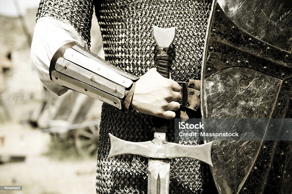 Man in suit of armor with medieval sword  Knight - Person Stock Photo