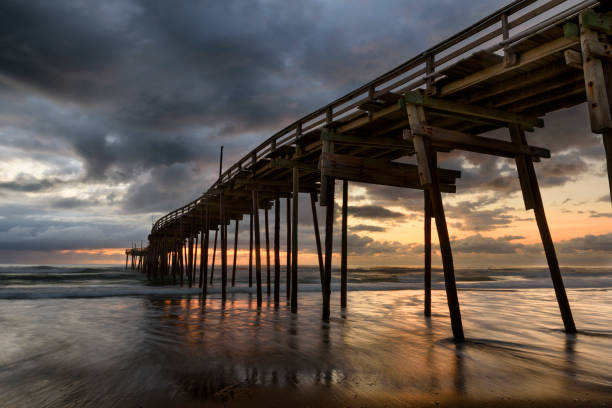 istock Fishing Pier with Colorful Sunrise and Dramatic Sky 956609910