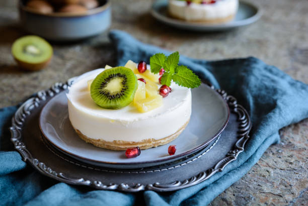 Unbaked mini cheesecakes topped with pineapple, kiwi and pomegranate