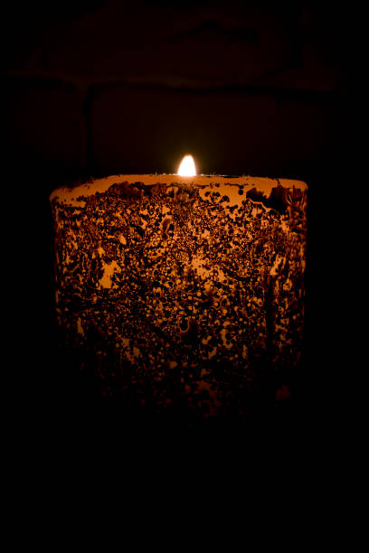 istock a burning candle in the dark 956618982