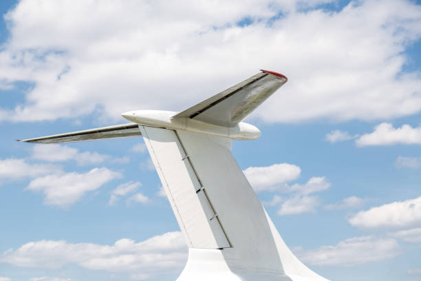 istock Airplane tail close-up. Aircraft part against blue sky with clouds background. Copyspace 956622838