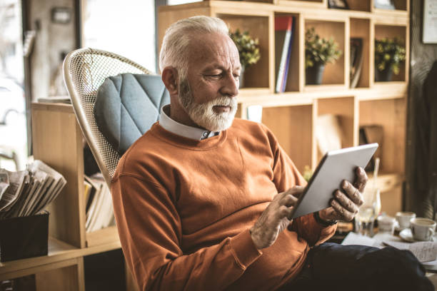 istock Senior businessman at his home using digital tablet. 956631832