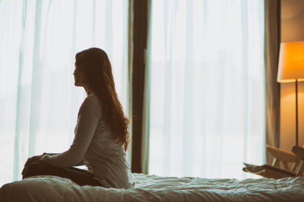 istock Woman contemplating sitting on her bed 956631876