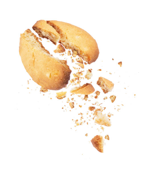 istock Cookies broken into two halves with falling crumbs down 956634702
