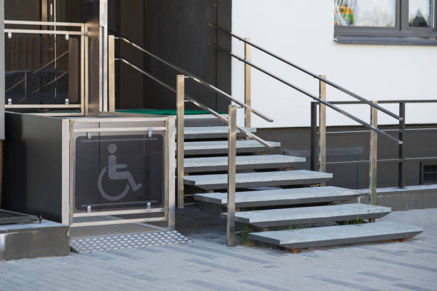 Living house entrance equipped with special lifting platform for wheelchair users stock photo