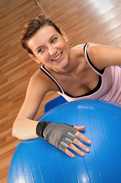 Woman Exercising on a Pilates Ball stock photo