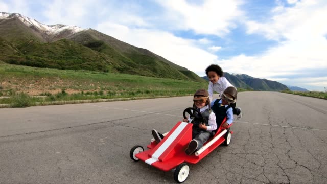 Young Business Team Races a Go Cart
