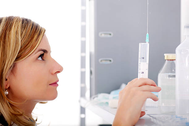 istock Young female doctor holding a syringe. 95664828