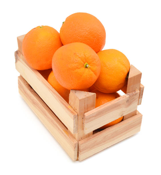 istock fresh oranges  in a wooden box on a white background 956651520