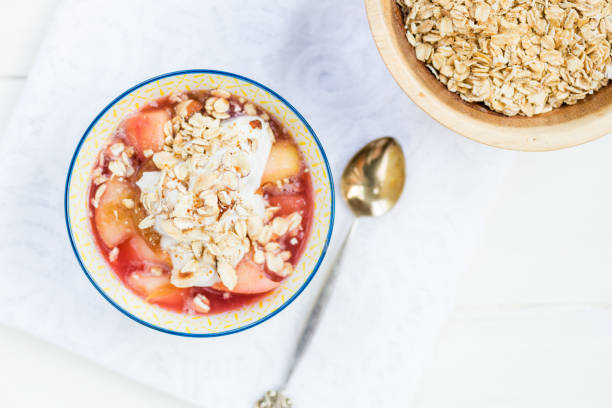 Rhubarb and apple compote with coconut yogurt and oatmeal Homemade rhubarb and apple compote with coconut yogurt and oatmeal, healthy detox snack apple compote stock pictures, royalty-free photos & images