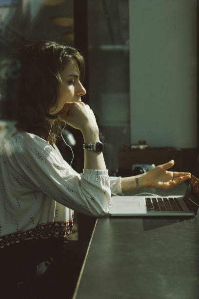 Young woman using laptop in a cafe