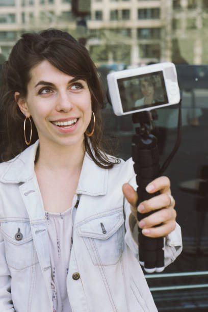 istock Young woman vlogging outdoors 956663650