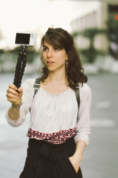 istock Young woman vlogging outdoors 956663680