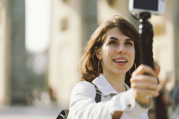 istock Young woman vlogging outdoors 956663950