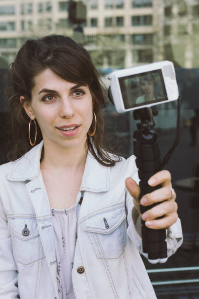 istock Young woman vlogging outdoors 956663980