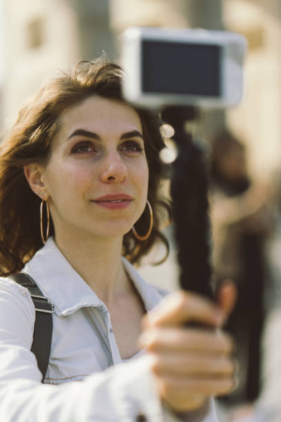 istock Young woman vlogging outdoors 956664032