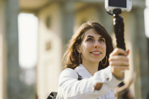 istock Young woman vlogging outdoors 956664072