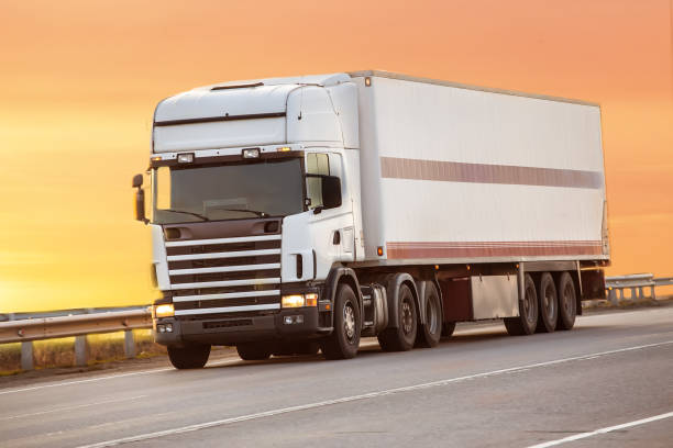 istock truck goes on highway on sunset 956672132