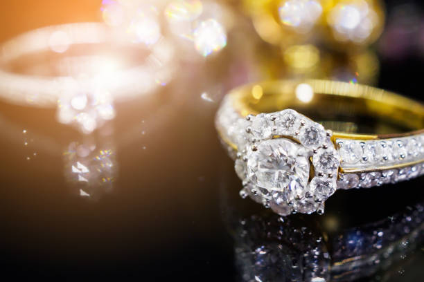 istock Jewelry diamond rings with reflection on black background 956676482