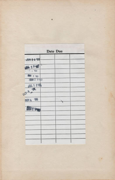 istock Vintage Library Due Date Card Attached to a Yellowed Book Page 956691620