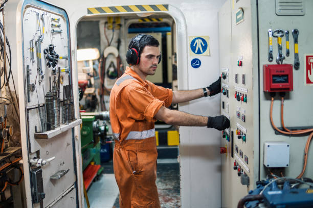 istock Marine engineer officer controlling vessel engines in engine control room ECR 956694264