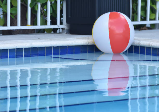 istock Red and White Beach Ball in Swimming Pool 956697288