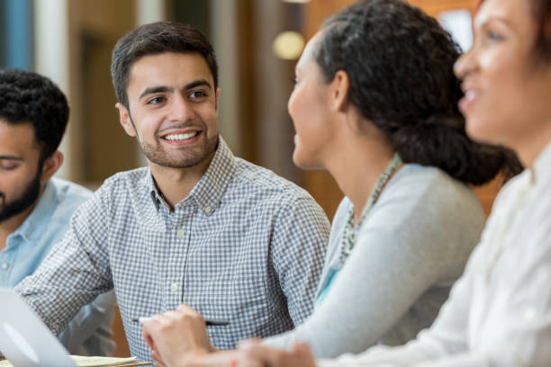 istock Young man enjoys talking with classmate after university lecture 956725700