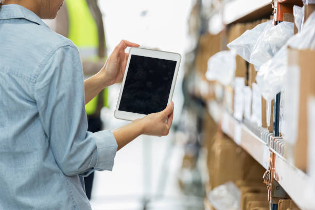 istock Warehouse employee uses digital tablet in warehouse 956728320