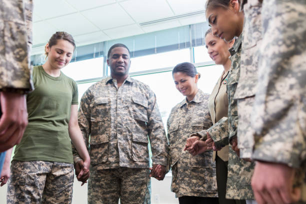 istock Group of praying army soldiers 956729748