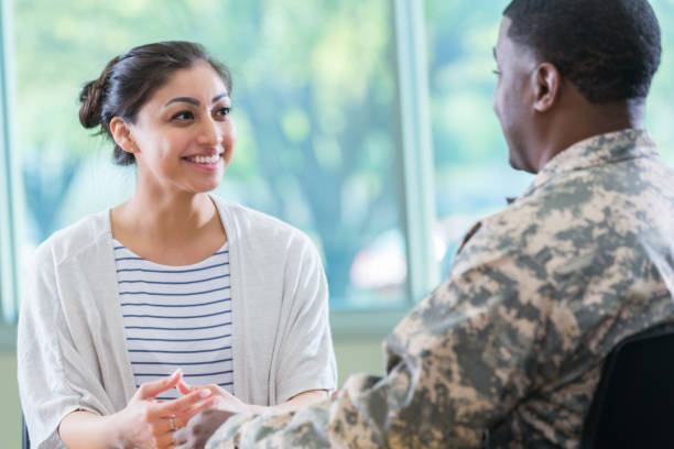 istock Young woman talks with army recruitment officer 956729778