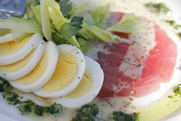 Hard boiled egg with tuna tartar and celery stock photo