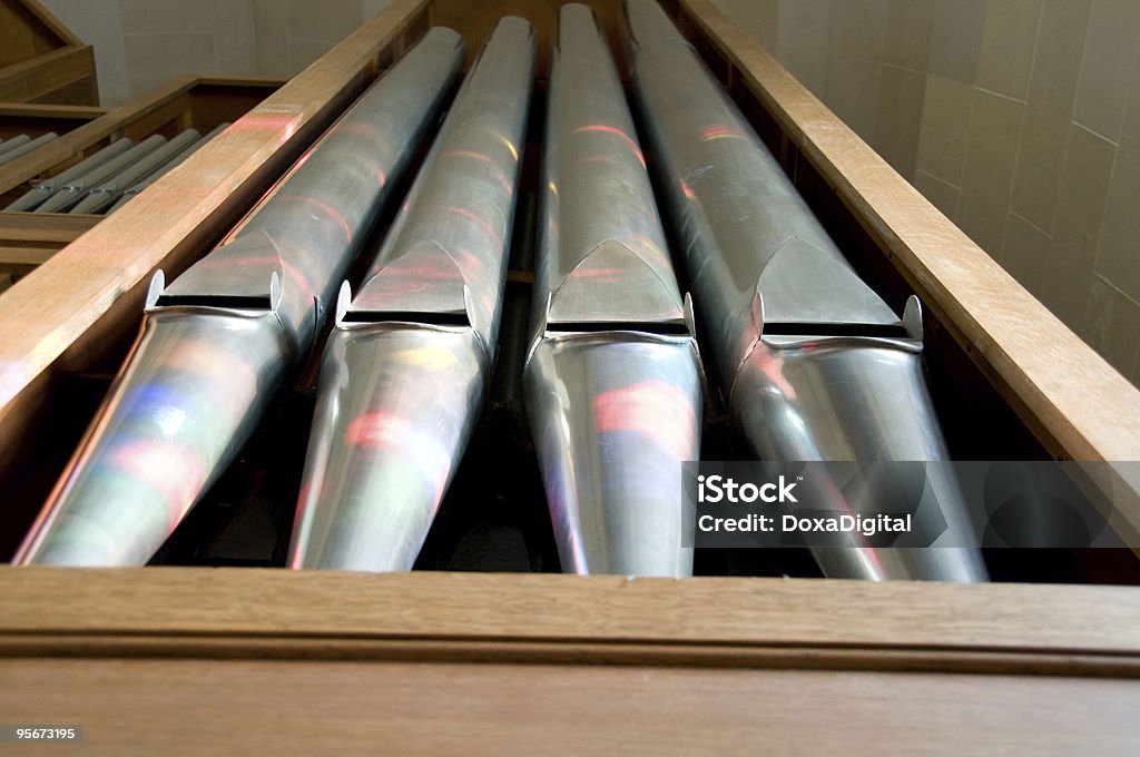 Church Organ Stained glass light plays off the pipes of a church organ. Pipe Organ Stock Photo