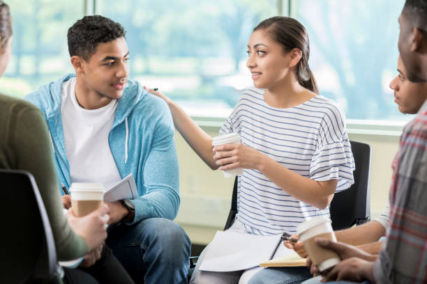 istock Woman comforts friend in support group 956732384