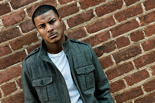 istock Casual Young Man in Front of Brick Wall 95674329