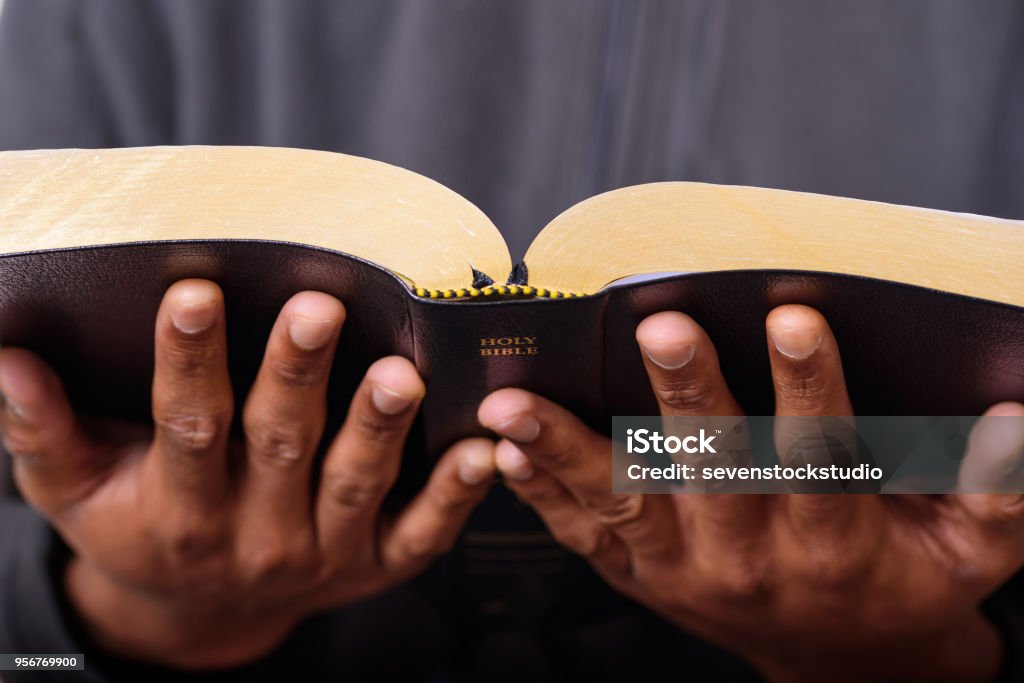 A Man Hands Holding The Holy Bible A close up view of a man hands holding the Holy Bible, Worship Concept Pastor Stock Photo