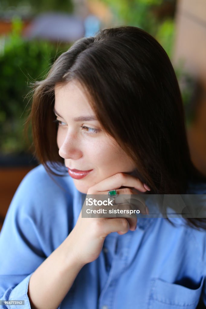 Close up beautiful caucasian woman with everyday makeup Close up beautiful caucasian woman with everyday makeup, wearing jeans shirt. Concept of beauty salon and cute appearance. Adult Stock Photo